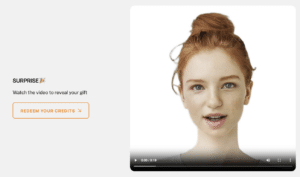 A red-haired woman with fair skin and tied-up hair appears in a paused Video Campaigns Pilot next to a message inviting the viewer to watch the video to reveal a gift.
