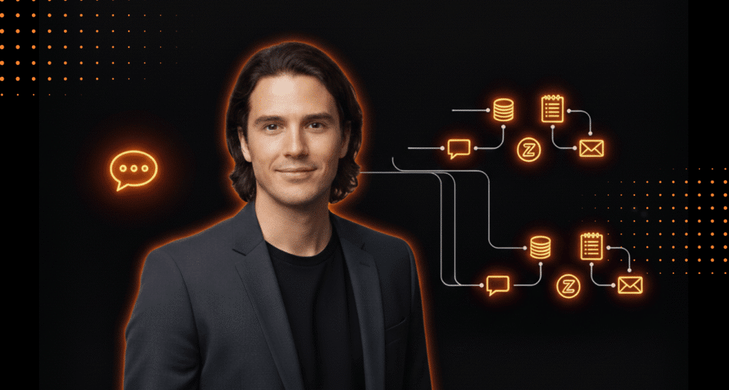 A man in a dark blazer stands in front of a black background with glowing orange icons representing data flow, communication, and messaging processes.